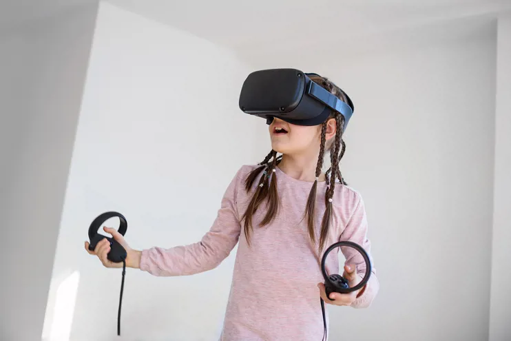 Young girl wearing virtual reality goggles