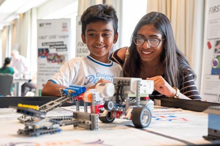 Young boy and mother at First Lego League event