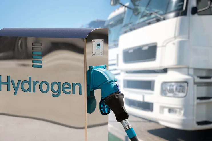 Hydrogen filling station with trucks in the background