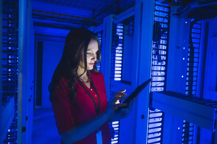 Caucasian businesswoman using a digital tablet in a server room
