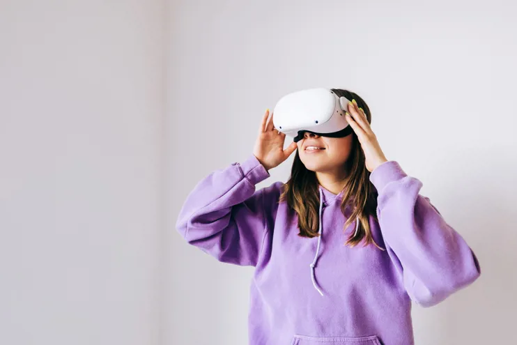 Young woman using VR headset