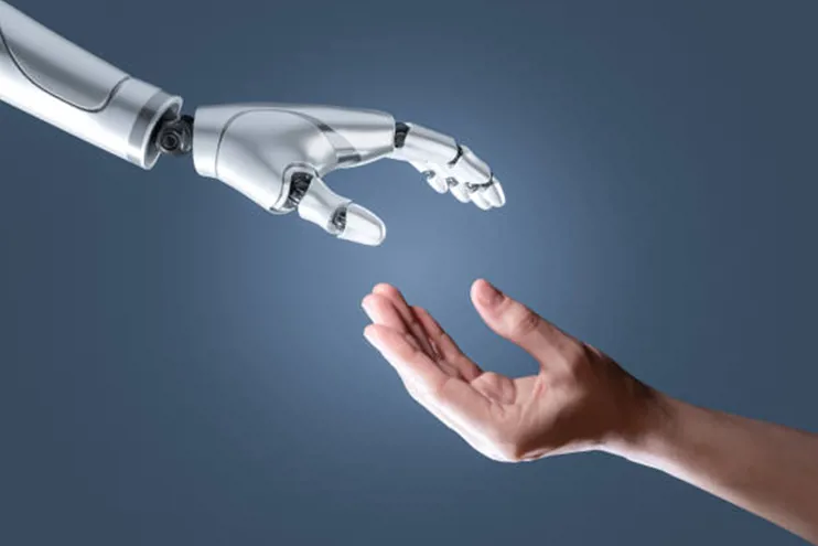 Robot arm reaching out to touch a human arm