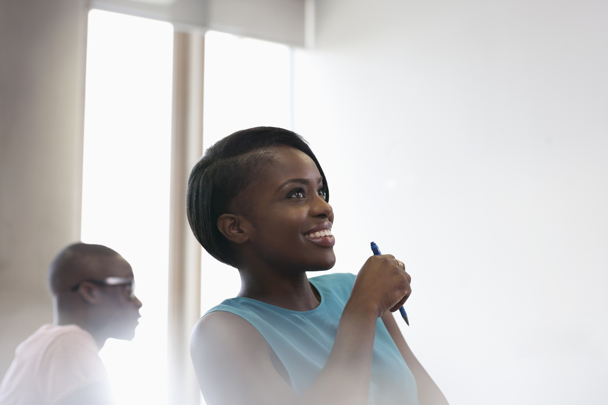 Smiling university student in blue top at seminar