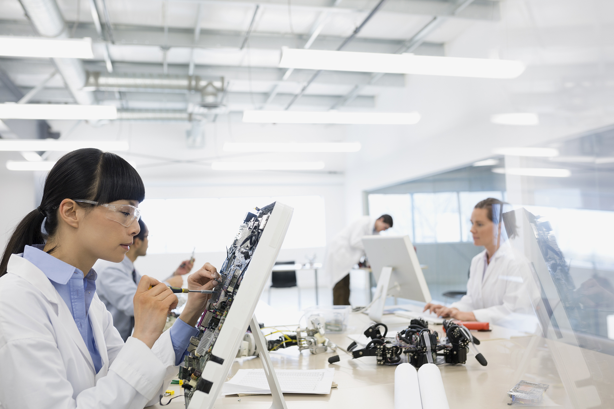 Female engineer working on electronics