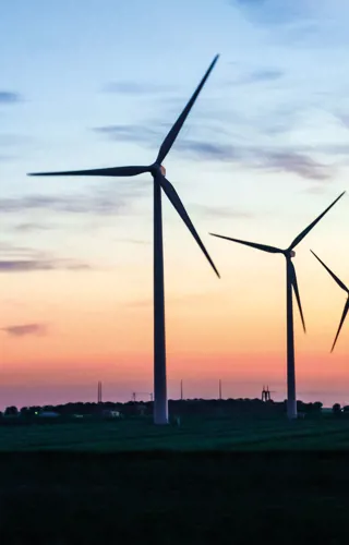 Row of wind turbines at dusk