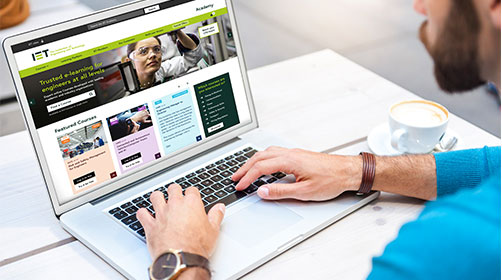 Man using computer accessing the IET website