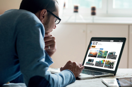 Man on laptop watching browsing webinars