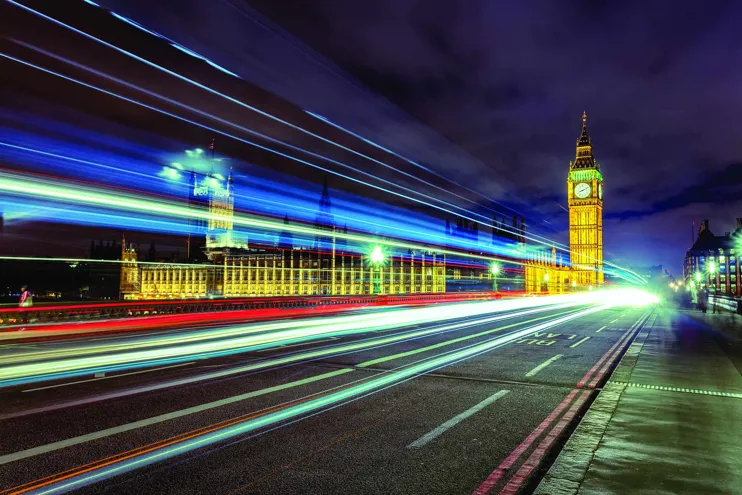 Time lapse image showing traffic passing the Palace of Westminster with the Elizabeth clock tower