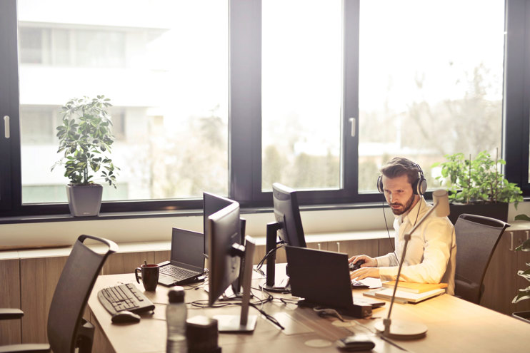 man-with-headphones-facing-computer-monitor.jpg