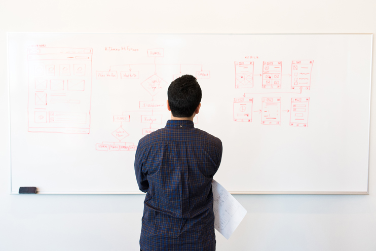 Man standing in front of white board