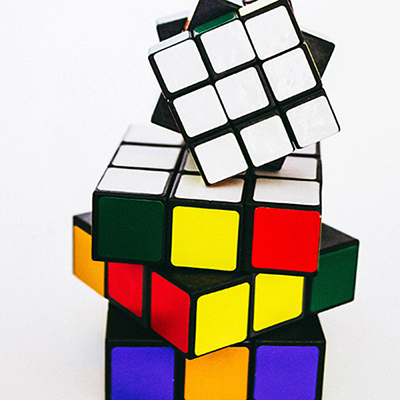 Image of two unfinished Rubics cubes stacked on top of each other