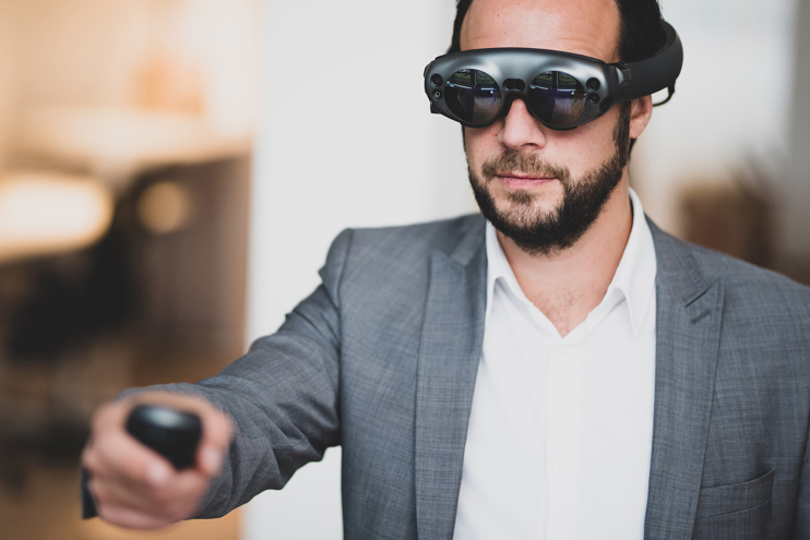 Man in suit wearing VR goggles