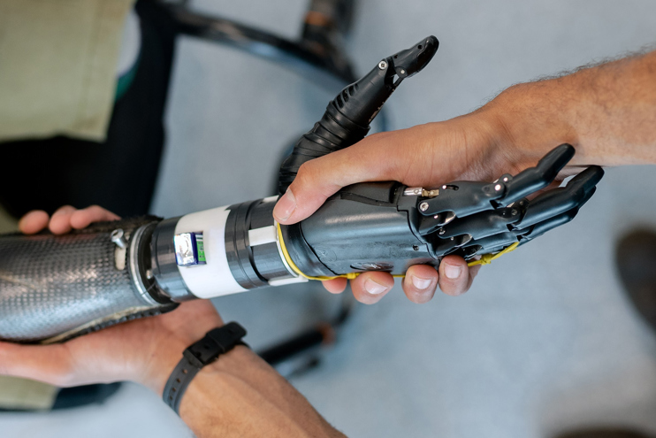 Robotic and human shaking hands