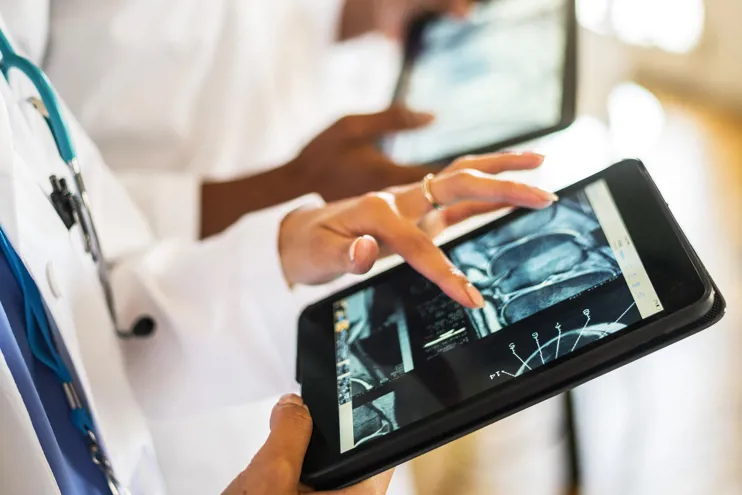 Doctors working with digital tablet