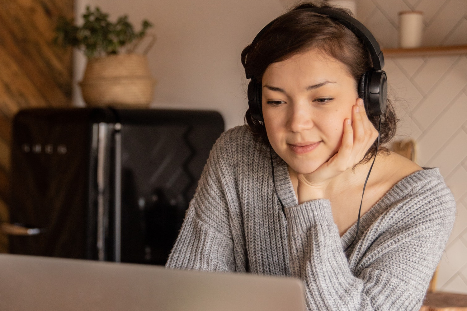 Women watching a technical webinar wearing headphones