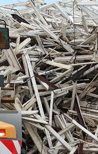 Pile of waste with industrial machinery in front