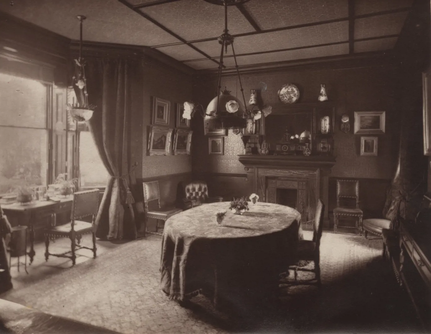Early electric lighting in a domestic setting; a dining room from Robert Hamond's book 'The Electric Light in our Homes' c1884.