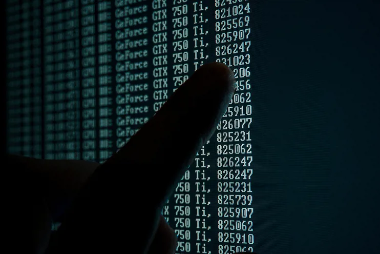Person examining computer code on a screen