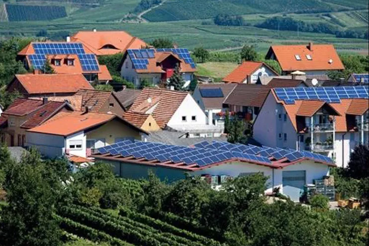 Village with majority of roofs covered in solar panels